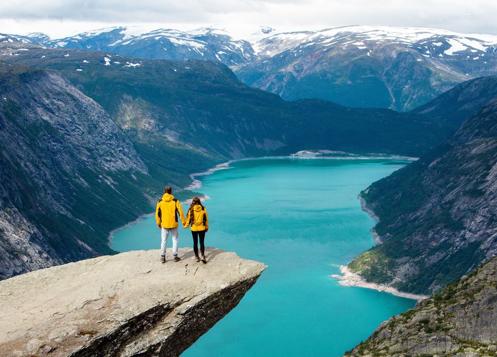 Hikers couple enjoying view on the top of mountain