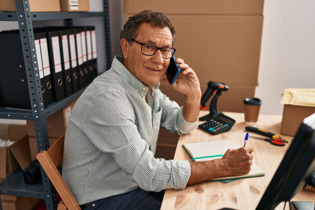 Senior business owner talking over the phone