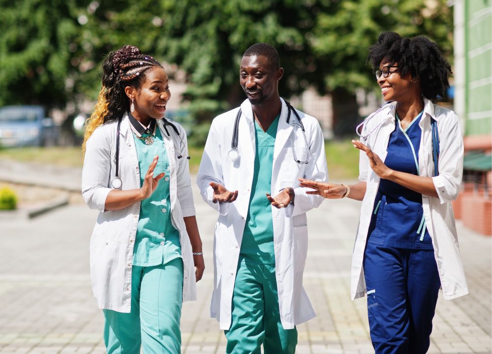 Group of nurses walking towards the camera talking 